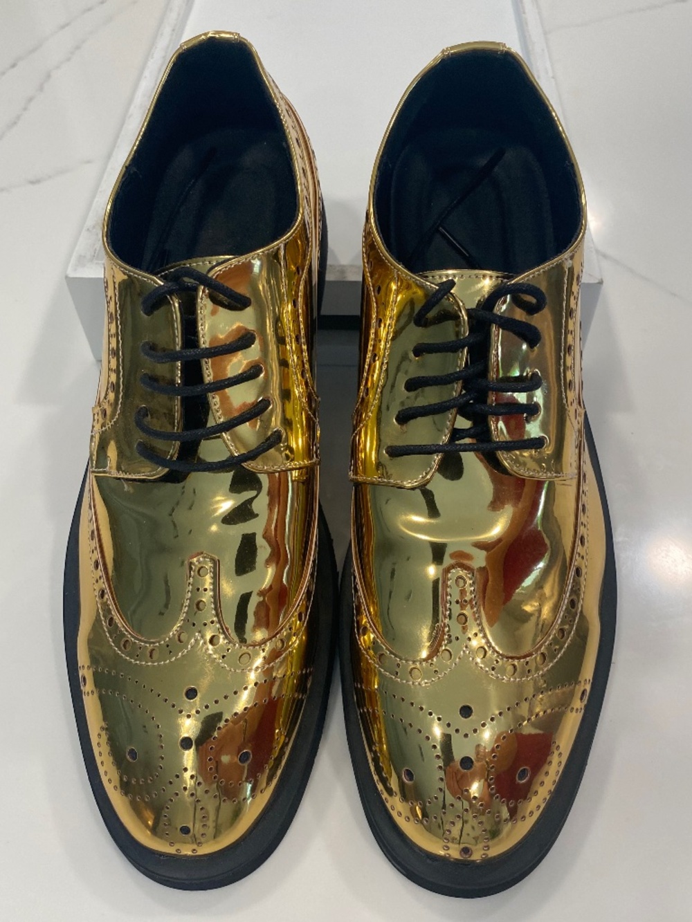 Metallic gold wing tip dress shoes